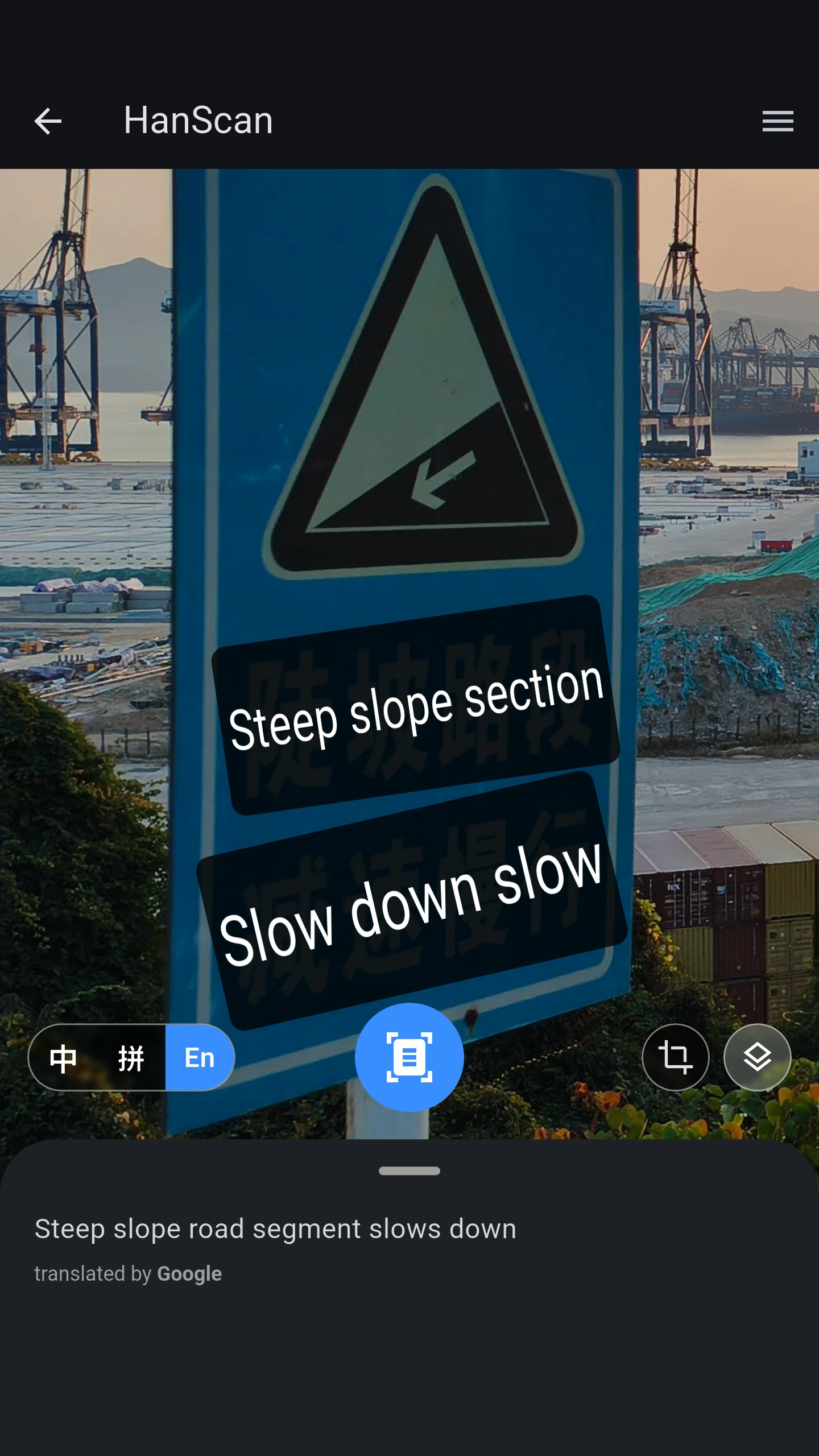 HanScan translating a Chinese road sign in English mode, with the recognized text shown over a steep-slope warning sign.